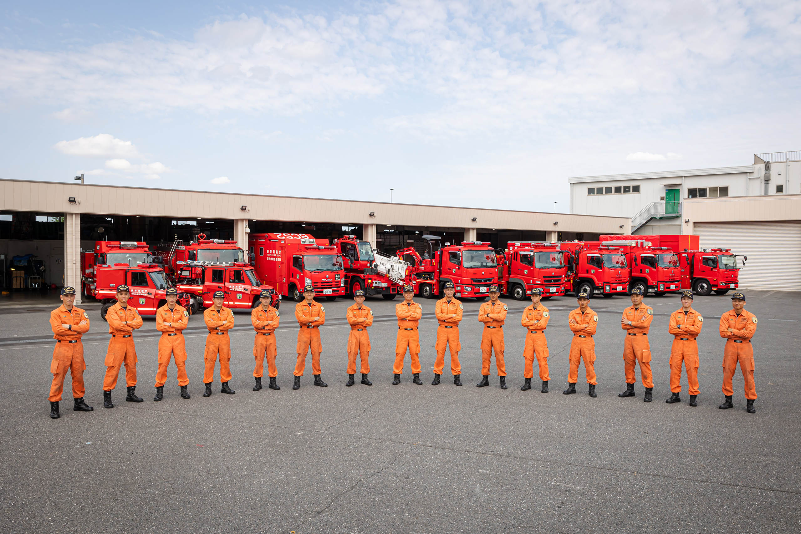 Hyper Rescue members line up in front of special vehicles.